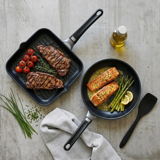 מארז מחבתות 28 ס"מ גריל + 24 TITANIUM FLAME ידית שחורה | Create a single, hyper-realistic overhead (top-down) food photography shot, in the natural editorial style of "Visual Reference 1" — same soft window-light qual