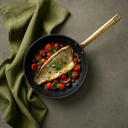 מחבת 32 ס"מ ENIGMA NONSTICK שחור ידיות זהב | Create a single, hyper-realistic overhead (top-down) food photography shot, in the natural editorial style of "Visual Reference 1" — same soft window-light qual