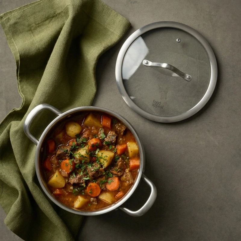 סיר נירוסטה 18 ס"מ 2 ליטר BELLA | Create a single, hyper-realistic overhead (top-down) food photography shot, in the natural editorial style of "Visual Reference 1" — same soft window-light qual