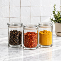 סט 3 אחסוניות עגולות אקרילי 850 מ"ל CLEAR & FRESH | Create a premium eye-level lifestyle product photograph by placing the storage canisters from the source image into the scene from @visual reference 2.